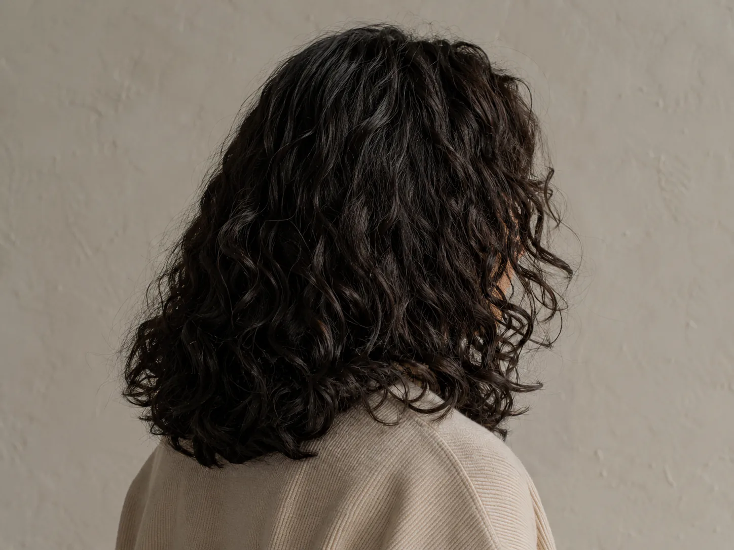 Edited result: Synthetic portrait with a fictional social handle crossing hair and clothing, before and after an authorized AI-assisted edit